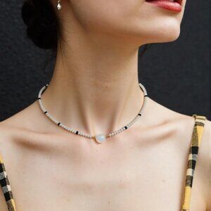 Frosted opulence. Milky facet crystal choker with accents of black facet beads.